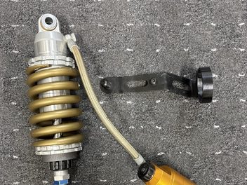 OHLINSリアショックアブソーバー単体。金色のスプリングとリザーバータンク