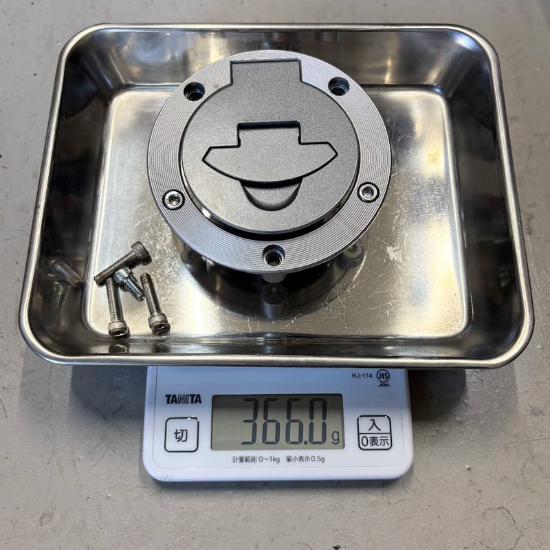 はかりに載せた純正タンクキャップとボルト4本。表示は366.0g