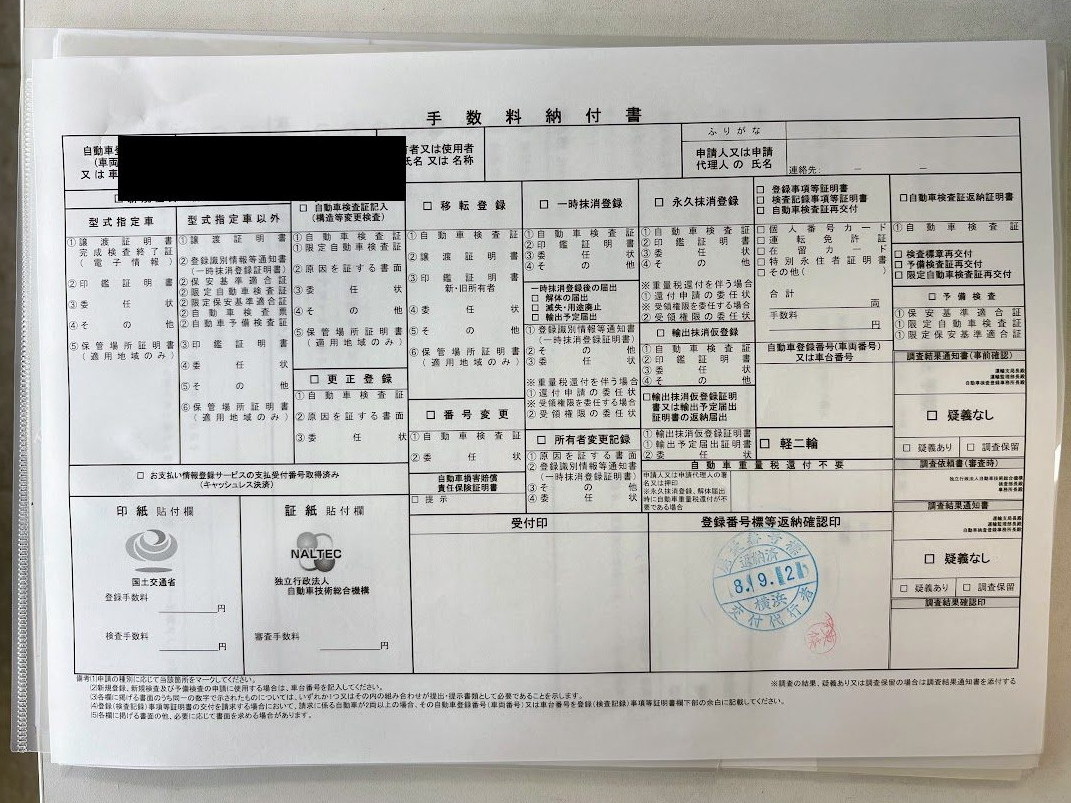 手数料納付書。目的欄に一時抹消登録などの選択肢が並ぶ様式で、下に印紙貼付欄がある。手書きの自動車登録番号は黒塗り